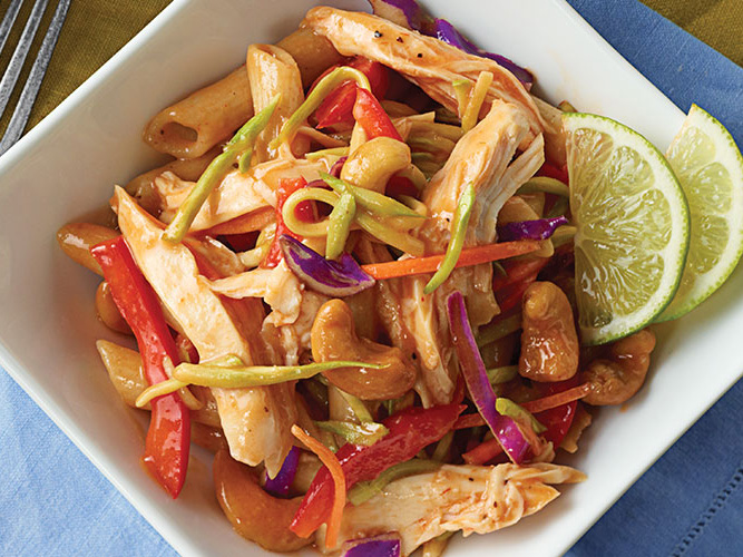 Pasta Salad in a white square bowl with lime wedges and Dorothy Lynch