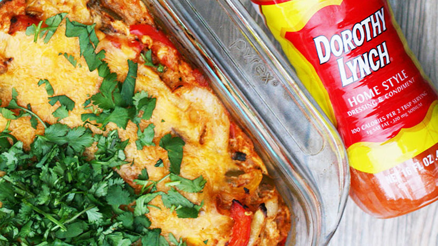 Chicken Fajita Bake in a clear pyrex pan with a Dorothy Lynch bottle laying beside