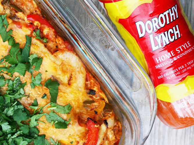 Chicken Fajita Bake in a clear pyrex pan with a Dorothy Lynch bottle laying beside