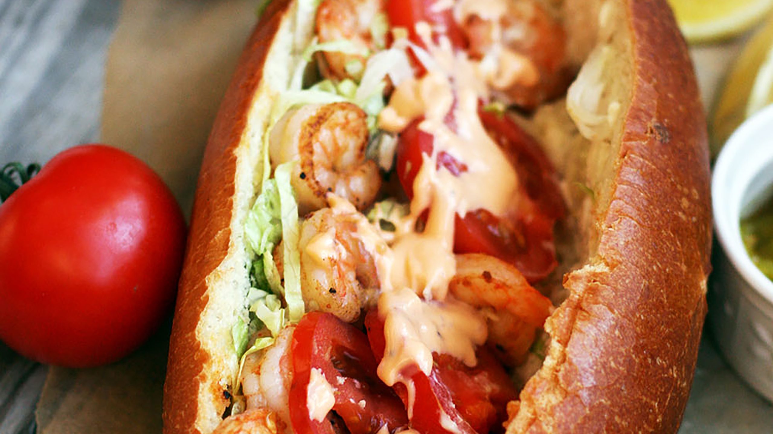 Tailgating Shrimp Po'Boy Sandwich with the bottom of a Dorothy Lynch bottle in view laying beside