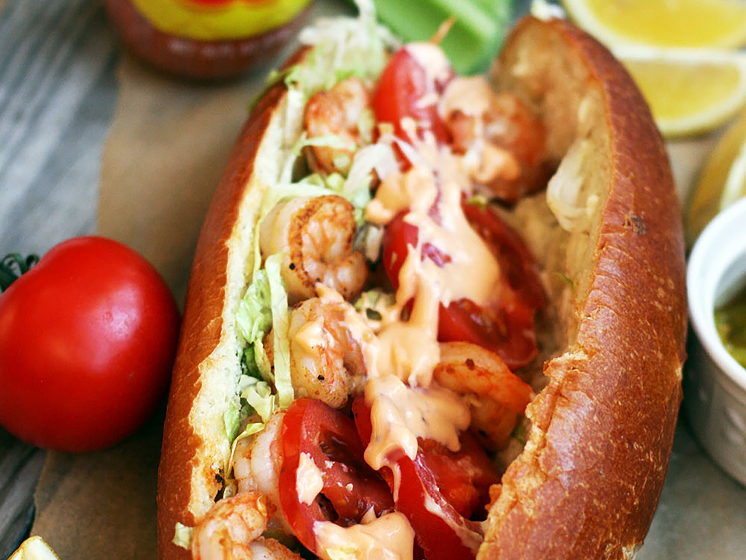 Tailgating Shrimp Po'Boy Sandwich with the bottom of a Dorothy Lynch bottle in view laying beside