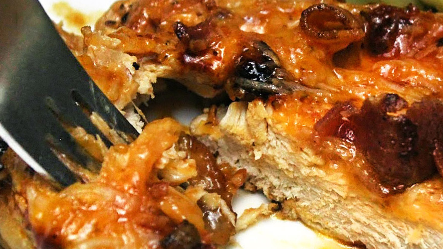 Tearing off a piece of Tasty Cheesy Chicken with Bacon with a fork