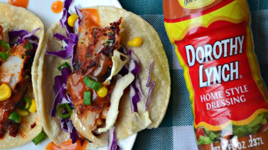 Dorothy Lynch Baked Fish Tacos laying next to a bottle of Dorothy Lynch