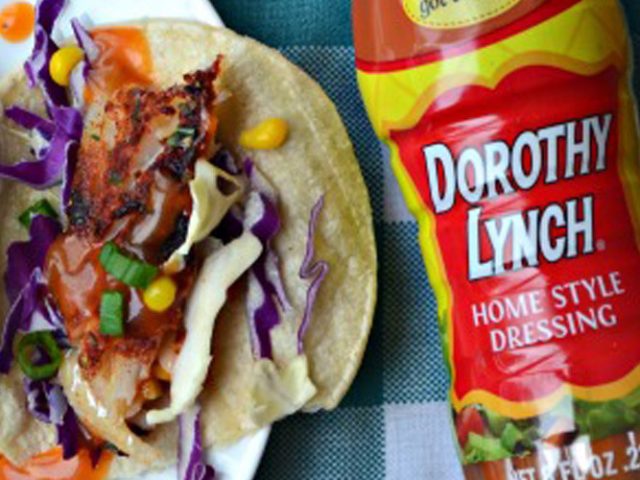 Dorothy Lynch Baked Fish Tacos laying next to a bottle of Dorothy Lynch