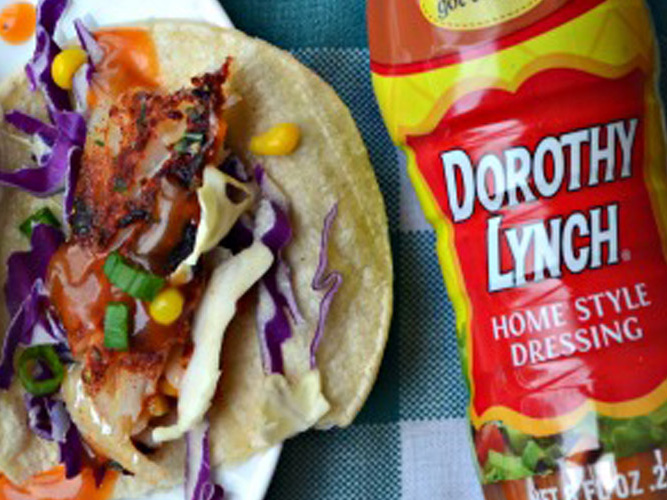 Dorothy Lynch Baked Fish Tacos laying next to a bottle of Dorothy Lynch
