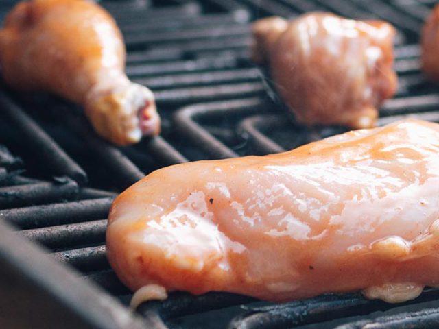 Drunken Dorothy chicken marinade recipe- raw chicken cooking on grill