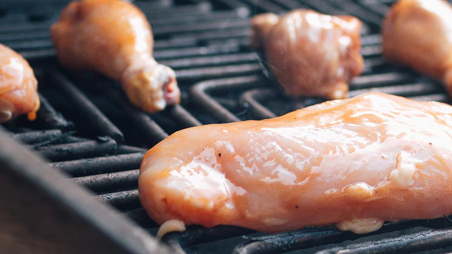 Drunken Dorothy chicken marinade recipe- raw chicken cooking on grill