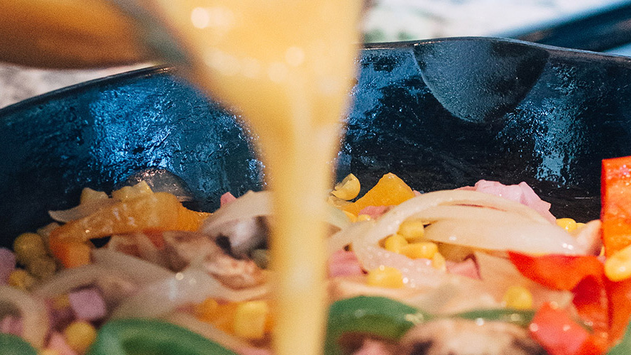 Egg being poured in a cast iron skillet to make Dorothys Brunch Vegetable Frittata Recipe