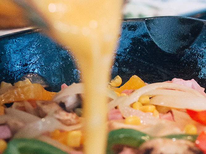Egg being poured in a cast iron skillet to make Dorothys Brunch Vegetable Frittata Recipe