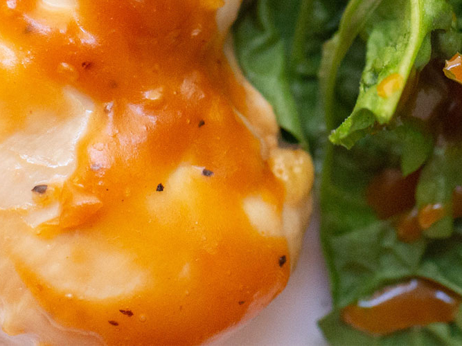 Honey and Dorothy Lynch Chicken with some greens next to it