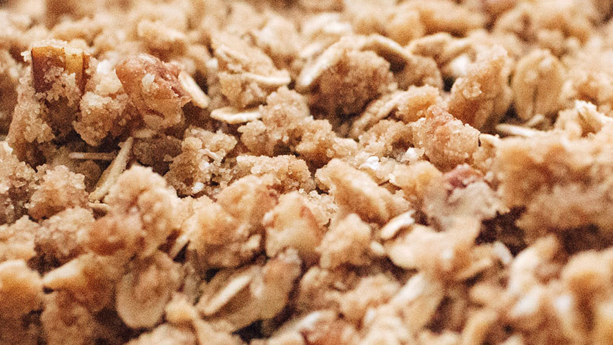 Very zoomed in image of Dorothy Lynch Gluten Free Peaches & Honey Crisp, looks like oats or granola