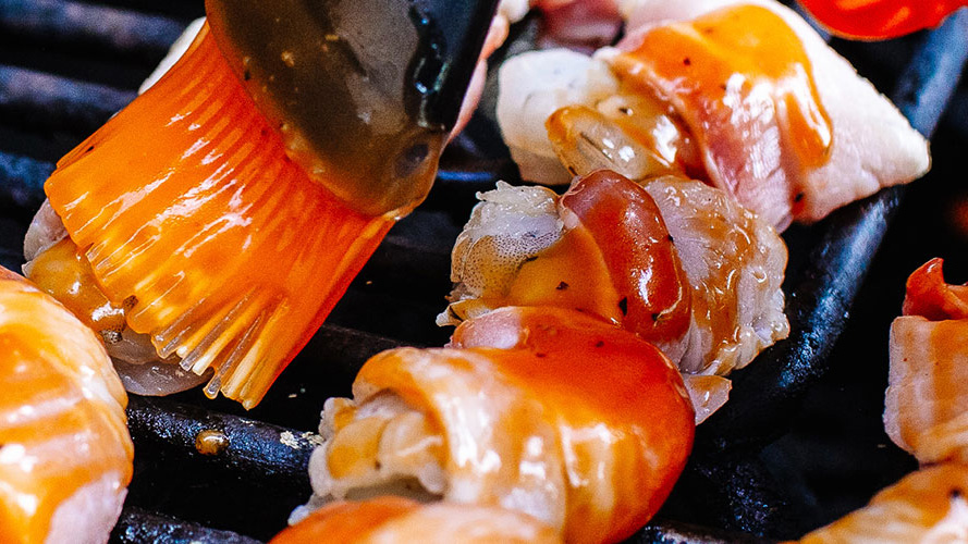Brushing on Dorothy Lynch to Shrimp Skewers on the grill
