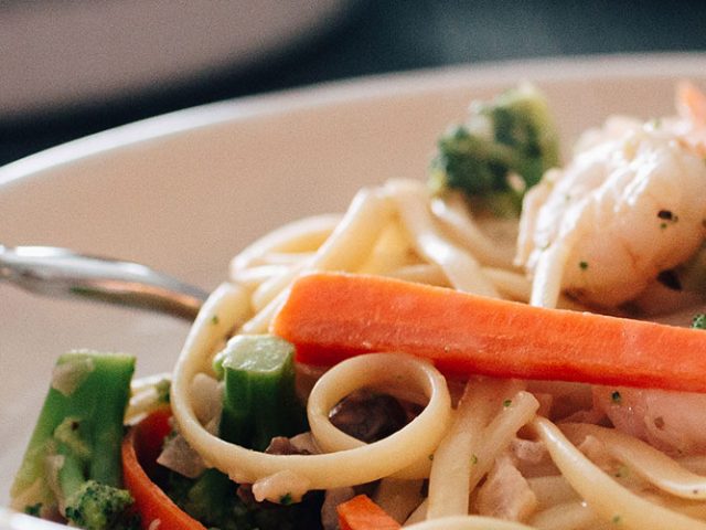 Close-up image of Creamy Linguine with Shrimp and Veggies with Dorothy Lynch Dressing Recipe in a white bowl