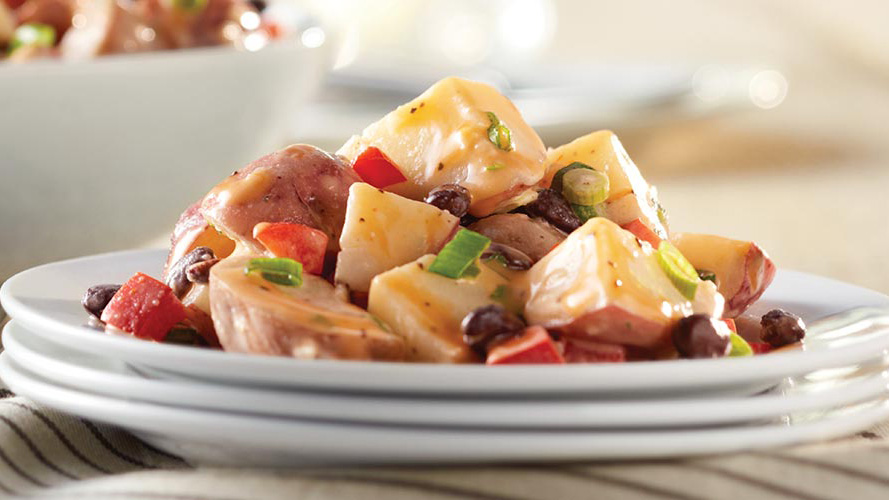 Dorothy’s Santa Fe Potato Salad Recipe on three white plates stacked on top of each other
