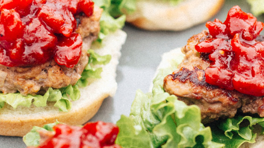 Two Grilled Turkey Sliders with Tomato Jam and lettuce