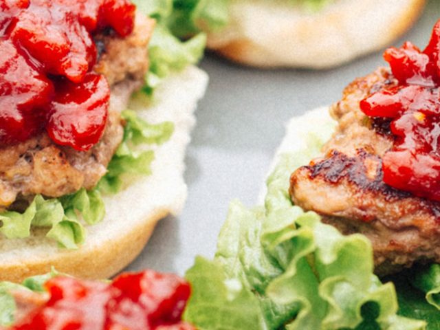 Two Grilled Turkey Sliders with Tomato Jam and lettuce