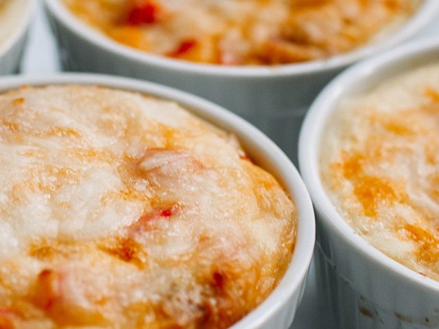 Individual white ramekins of Roasted Pepper and Ham Quiches with Dorothy Lynch Dressing Recipe
