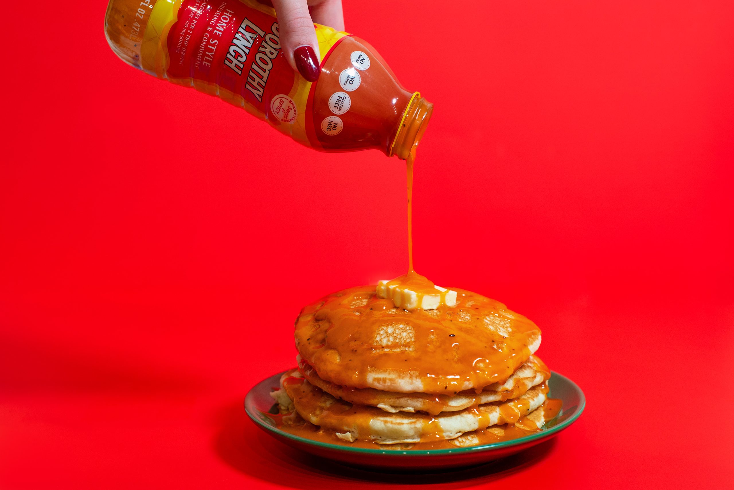 Stack of buttermilk pancakes with Dorothy Lynch Dressing drizzled over it