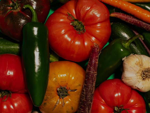 Fresh vegetables that cover every inch of the frame, Tomato, Jalapeño, Carrots, Garlic, etc