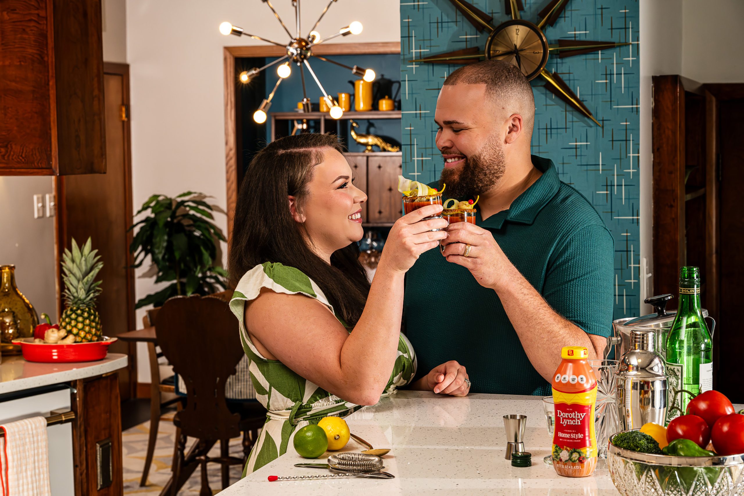 Midwestern couple with Dorothy Lynch Dressing Doing a "Cheers" Pose with Bloody Mary Drinks